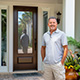 Customer standing next to entry door installed by Pacer Door.