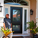 Customer standing next to entry door installed by Pacer Door.