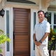 Customer standing next to entry door installed by Pacer Door.