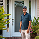 Customer standing next to entry door installed by Pacer Door.