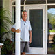 Customer standing next to entry door installed by Pacer Door.