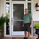 Customer standing next to entry door installed by Pacer Door.