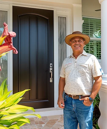 Customer standing in front of entry door installed by Pacer Door.